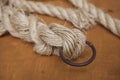 Coil of rope with a marine unit, and an iron ring. Royalty Free Stock Photo