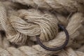 Coil of rope with a marine unit, and an iron ring. Royalty Free Stock Photo