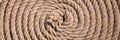 Coil of twisted strong brown rope as background texture