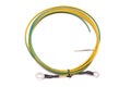 A coil of yellow green earthing grounding electrical wire with blank white label