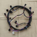 A coiled automotive wire harness with black, red, and blue wires. The cables are Royalty Free Stock Photo