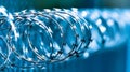 Coiled barbed wire on a metal fence functions as both a security barrier and a boundary delineation in an outdoor Royalty Free Stock Photo