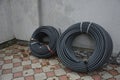 Coiled black plastic pipes stored outdoors Royalty Free Stock Photo