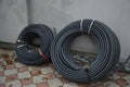 Coiled black plastic pipes stored outdoors Royalty Free Stock Photo