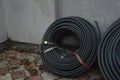 Coiled black plastic pipes stored outdoors Royalty Free Stock Photo