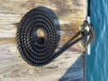 Coiled black rope on dock Royalty Free Stock Photo