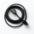 Coiled Black USB Data Cable on White Background Royalty Free Stock Photo