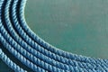 Coiled blue rope on tarpaulin