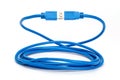 Coiled blue USB 3 extension cable. Royalty Free Stock Photo