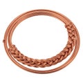 A coiled copper wire with a braided section in the middle against a white background Royalty Free Stock Photo