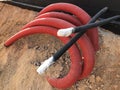 Coiled corrugated pipes and high voltage cables