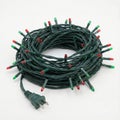 Coiled green string lights plug Royalty Free Stock Photo