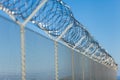 Coiled razor wire on top of a fence Royalty Free Stock Photo