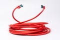 Coiled red ethernet cable with two RJ45 plugs