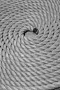 A coiled rope on the pier black and white picture Royalty Free Stock Photo