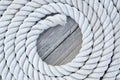 Coiled rope sits on a an old wooddn dock Royalty Free Stock Photo