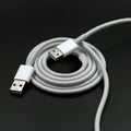 Coiled USB cable with standard Type-A connectors at both ends. The cable is white and Royalty Free Stock Photo