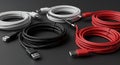 Coiled USB cables in white, black, and red are arranged on a dark surface. Each cable Royalty Free Stock Photo