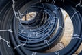 Coils of black polyethylene pipes for laying high voltage electrical cables underground at a construction site