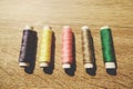 The coils of threads put on wooden table Royalty Free Stock Photo