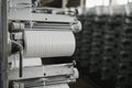 Coils of white flat polypropylene yarn for the production of industrial bags. circular loom woven bag machine. Production of