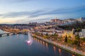 Coimbra drone aerial city view at sunset with colorful fountain in Mondego river and beautiful historic buildings, in Portugal Royalty Free Stock Photo