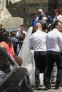 Bride, groom and wedding guests in front of the church Se Velha