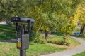 Coin binoculars on a background of landscape: green trees and gr