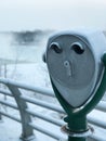 Coin binoculars covered with ice during winter Royalty Free Stock Photo