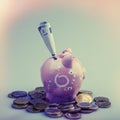 Coin box and euro coins and bills on an violet background. Euro Royalty Free Stock Photo