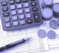 Coin, a calculator, a pen on the business papers Royalty Free Stock Photo