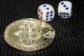 Coin cryptocurrency bitcoin and rolling dice. Royalty Free Stock Photo