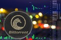 Coin cryptocurrency bittorrent on night city background and chart.