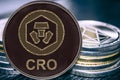 Coin cryptocurrency CRO Crypto Chain Com on the background of a stack of coins. Royalty Free Stock Photo