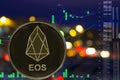 Token cryptocurrency EOS on night city background and chart. Royalty Free Stock Photo