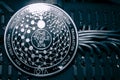 Coin cryptocurrency iota on the background of wires and circuits. altcoin miota