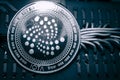 Coin cryptocurrency iota on the background of wires and circuits. altcoin miota