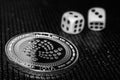 Coin cryptocurrency iota and rolling dice.
