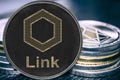 Coin cryptocurrency link chainlink on the background of a stack of coins.