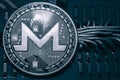 Coin cryptocurrency Monero on the background of wires and circuits. XMR