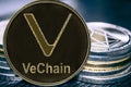 Coin cryptocurrency VeChain VET on the background of a stack of coins. MKR