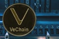 Coin cryptocurrency VeChain VET against the numbers of the arithmometer.