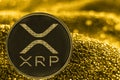 Coin cryptocurrency xrp on golden background.