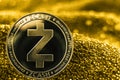 Coin cryptocurrency Zcash on golden background.