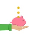 Coin depositing in a money piggy bank on human hands Royalty Free Stock Photo