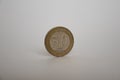 COIN FIFTY YENI KURUS STANDS VERTICALLY ON THE WHITE BACKGROUND