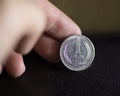 A Silver Coin hold y a hand Closeup