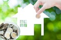 Coin Hand holding house icon in nature as symbol of mortgage,Dream house on nature background Royalty Free Stock Photo