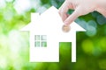 Coin Hand holding house icon in nature as symbol of mortgage,Dream house on nature background Royalty Free Stock Photo