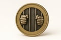 A coin with hands holding prison bars. Royalty Free Stock Photo